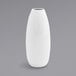 A close up of a Front of the House white porcelain bud vase with a white spiral design.