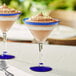 Two Acopa Tropic martini glasses filled with chocolate desserts with spoons.