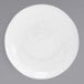 A white round porcelain sauce dish with a spiral design on the surface.