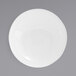 A white round porcelain bowl with a spiral design on it.
