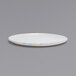 A white plate with a gold rim on a gray background.