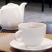 A close-up of a white Front of the House Spiral porcelain cup on a table.