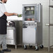 A man in a professional kitchen with a Beverage-Air double stacked undercounter freezer and refrigerator.