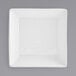 A white square porcelain bowl with a spiral pattern in the center.
