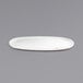 A white oval porcelain plate with a brown trim.