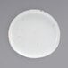 A white porcelain plate with brown specks.