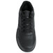 A close-up of a black Genuine Grip Women's Steel Toe Jogger shoe with black laces.