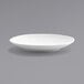 A white Front of the House Spiral porcelain plate with a small rim on a gray surface.