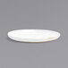 A Front of the House Artefact superwhite porcelain plate with a gold rim on a white background.