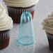 A close-up of a cupcake with blue star-shaped frosting on top.