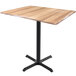 A Holland Bar Stool EnduroTop natural wood laminate bar height table with a black cross base.
