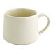 A plain, off-white porcelain cup with a handle.