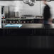 A man using a Vollrath 6-board cutting board system in a kitchen.