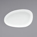 A white oval plate on a gray surface.