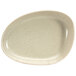 A white oval porcelain plate with specks.