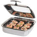 A stainless steel Vollrath Intrigue chafer with food in a stainless steel tray.