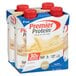 A group of Premier Protein Vanilla Protein Shake cartons with red plastic caps.