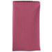 A folded mauve Intedge cloth napkin.