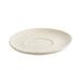 A white porcelain saucer with specks on it.