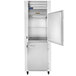 A white Traulsen G Series reach-in freezer with a door open.