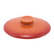 A red Kiln stoneware lid with a small orange button on top.