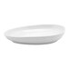 An oval-shaped, white porcelain plate with a smooth finish.