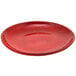 a red plate with black speckled texture