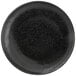 A black porcelain plate with a black pepper speckled rim.