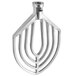 An aluminum flat beater attachment with a large circular design and holes.