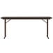 A Correll walnut rectangular seminar table with black legs.
