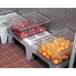 A plastic Cambro dunnage rack holding several containers of fruit.