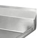 A white Advance Tabco fabricated metal two compartment sink with a metal drainboard.