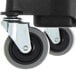 A close-up of a Carlisle black trash can dolly wheel.