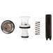 A close-up of a white and black T&S valve repair kit with a circular object and a black rectangular object with a number on it.