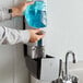A person's hands using a Rubbermaid Autofoam soap dispenser.