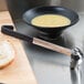 A bowl of soup and a Vollrath Jacob's Pride ladle on a counter.