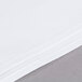 A stack of white Intedge square cloths on a table.