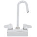 A silver Equip by T&S wall mounted faucet with gooseneck spout and lever handles.