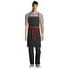 Uncommon Threads 3104 Black Poly-Cotton Rebel Bib Apron with Red Webbing and 3 Pockets - 34 inchL x 36 inchW
