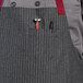a person wearing a apron with a pen and a tool in it