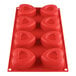 A red Thunder Group heart shaped silicone mold with 8 compartments.