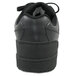 A close up of a black Genuine Grip leather shoe with a rubber sole and laces.
