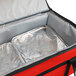 a red and black bag with a silver tray inside