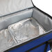 a blue and black cooler bag with silver foil inside