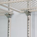 The interior of a white Beverage-Air MarketMax glass door refrigerator with metal shelves and metal rods.