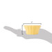 A hand holding a yellow CAC Festiware ramekin with a yellow cupcake inside.