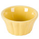 A yellow floral ramekin with wavy edges.