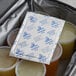 A Nordic foam brick cold pack on top of plastic containers in a bag.