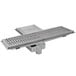 An Eagle Group Cool Trough floor drain with a fiberglass grating cover.