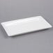 A white rectangular American Metalcraft stoneware platter on a gray surface.